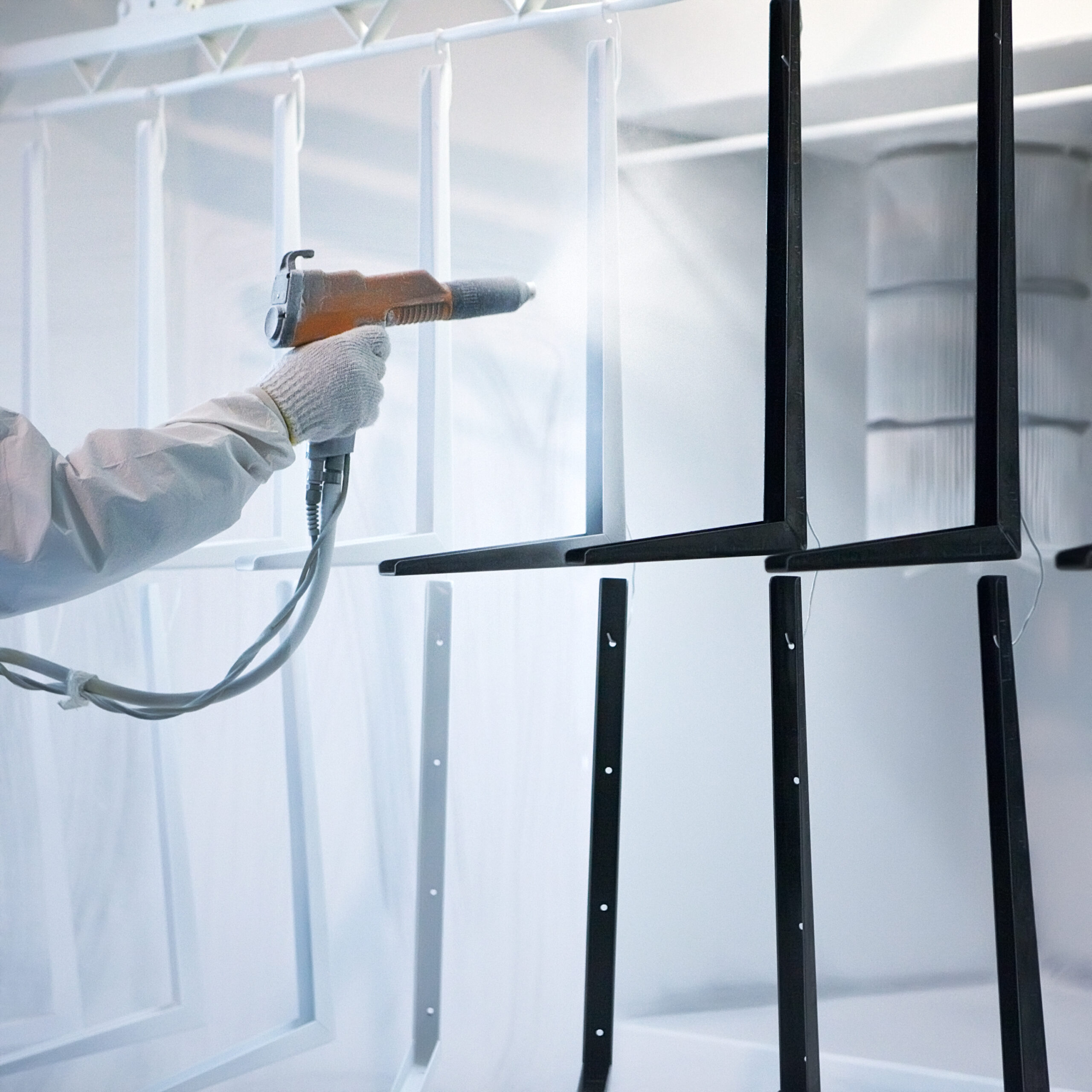 Hand holding powder coating sprayer